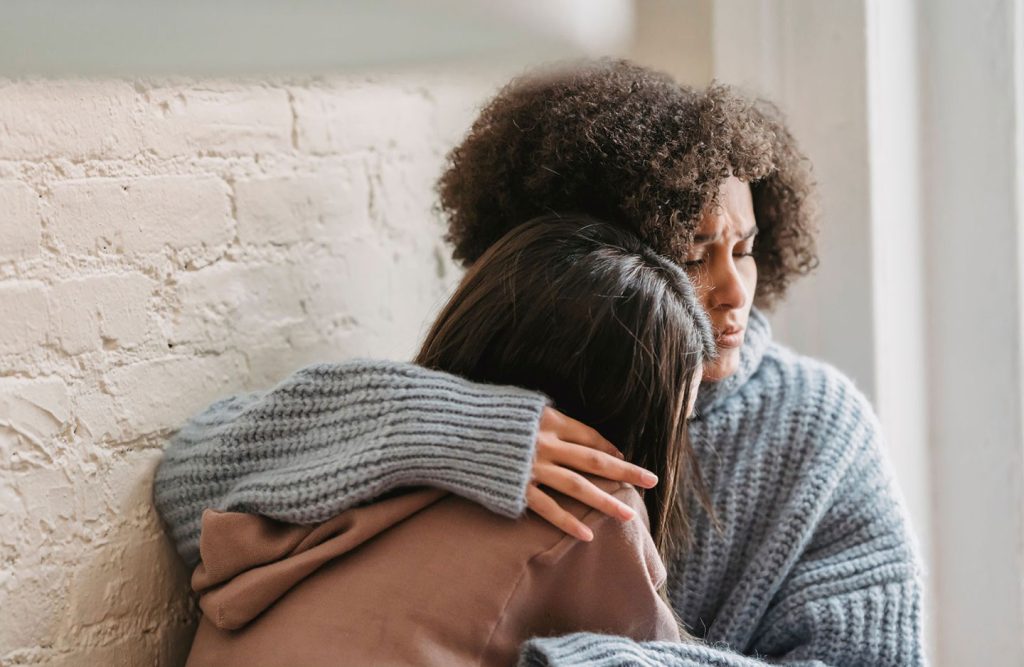 two people hugging for comfort