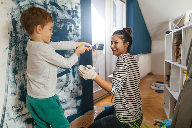 mom and son painting a room in their house