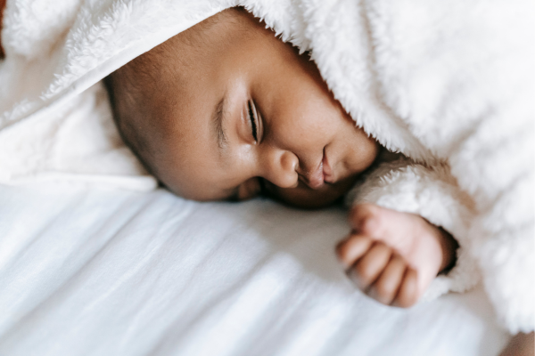 Young baby sleeping in blanket